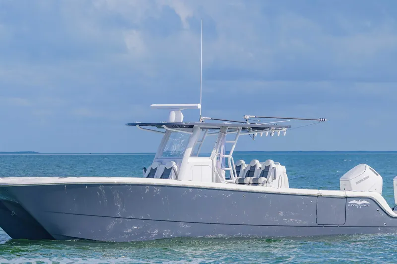 Slide: The Image of 2023 Invincible 35 Catamaran on calm ocean waters under a clear sky. - 2