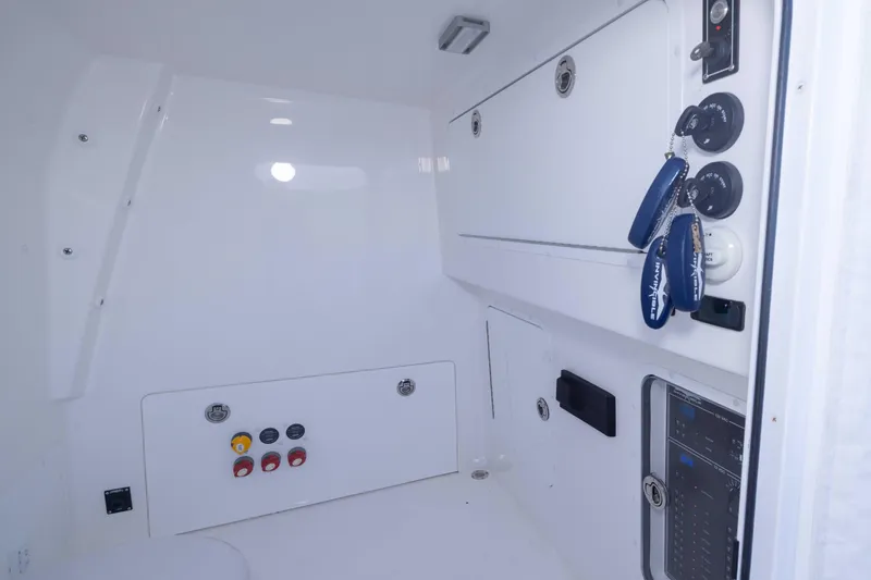 Slide: The Image of 2023 Invincible 35 Catamaran interior with control panel and storage compartments. - 25