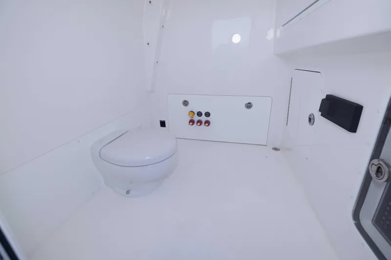 Slide: The Image of 2023 Invincible 35 Catamaran interior bathroom with modern white fixtures and control panel. - 26