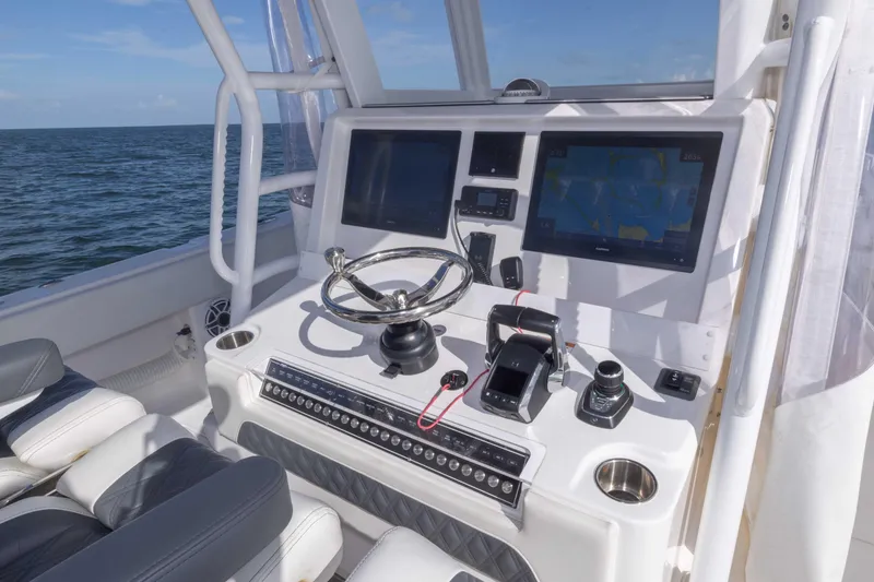 Slide: The Image of 2023 Invincible 35 Catamaran helm with advanced navigation systems and controls. - 29