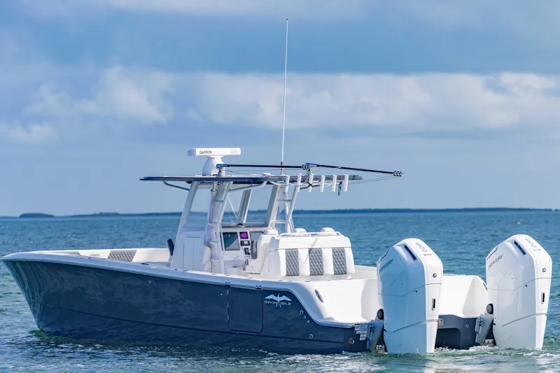 Slide: The Image of 2023 Invincible 35 Catamaran on calm ocean waters under a cloudy sky. - 3