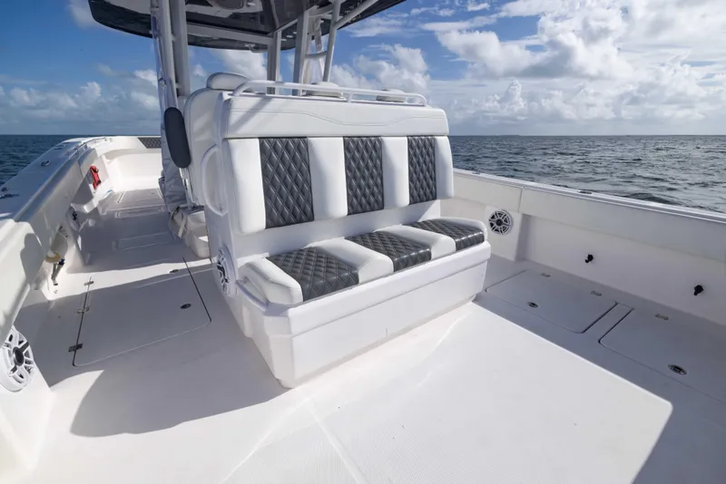Slide: The Image of 2023 Invincible 35 Catamaran interior with cushioned seating, ocean view, and clear skies. - 32