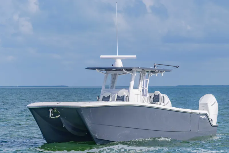 Slide: The Image of 2023 Invincible 35 Catamaran cruising on open water under a clear sky. - 4