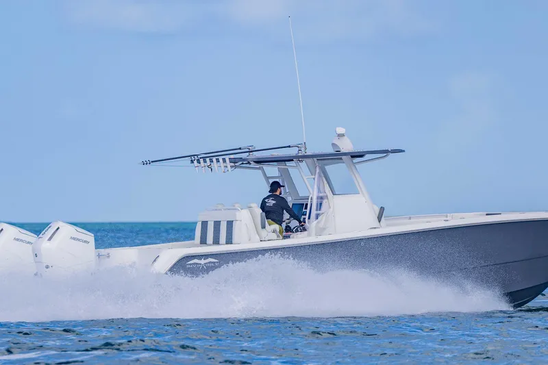 Slide: The Image of 2023 Invincible 35 Catamaran cruising on open water, showcasing powerful Mercury engines. - 9