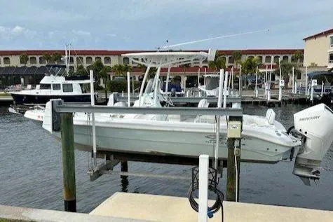 The Image of 2021 Glasstream 240 CCX boat docked near waterfront home with palm trees. - 0