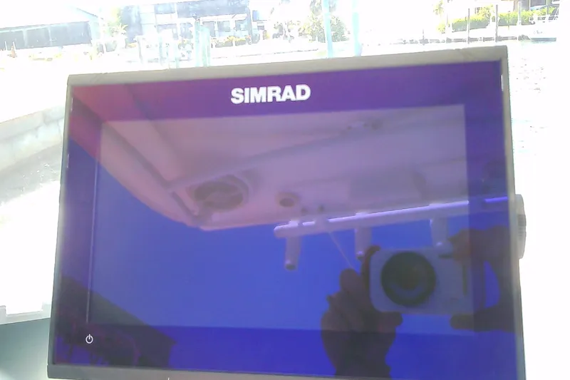 Slide: The Image of Simrad display on 2021 Glasstream 240 CCX boat, reflecting surroundings. - 14