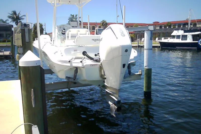 Slide: The Image of 2021 Glasstream 240 CCX boat docked on a lift by the water. - 16