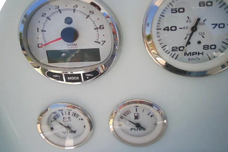 Slide: The Image of Dashboard gauges of a 2021 Glasstream 240 CCX boat, displaying RPM, speed, voltage, and fuel levels. - 19