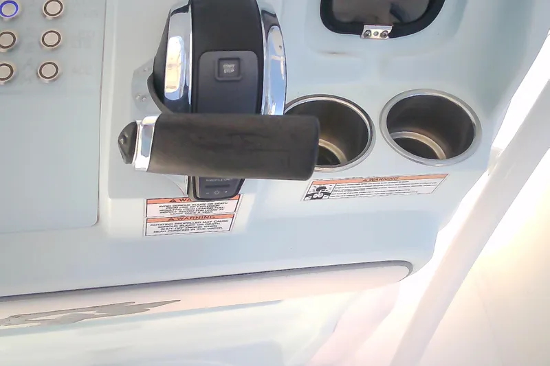 Slide: The Image of Control panel of 2021 Glasstream 240 CCX boat with throttle and cup holders. - 25