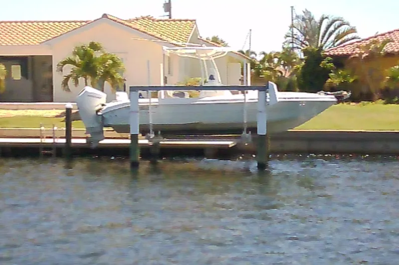 Slide: The Image of 2021 Glasstream 240 CCX boat on lift by waterfront home. - 29