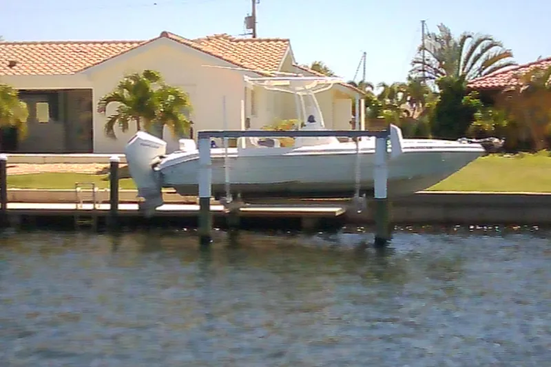 Slide: The Image of 2021 Glasstream 240 CCX boat docked by a waterfront home with palm trees. - 30
