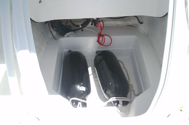 Slide: The Image of Storage compartment of 2021 Glasstream 240 CCX boat with black fenders and red wiring. - 32