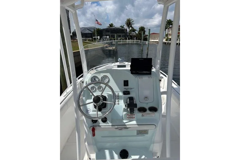 Slide: The Image of 2021 Glasstream 240 CCX boat docked on a sunny day by the water. - 4