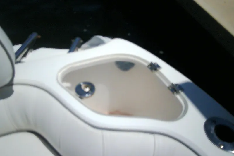 Slide: The Image of 2021 Glasstream 240 CCX boat interior with storage compartment and cup holder. - 40