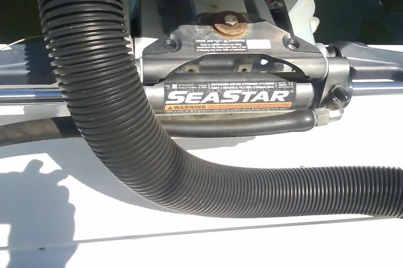 Slide: The Image of Hydraulic steering system on a 2021 Glasstream 240 CCX boat, featuring SeaStar components. - 49