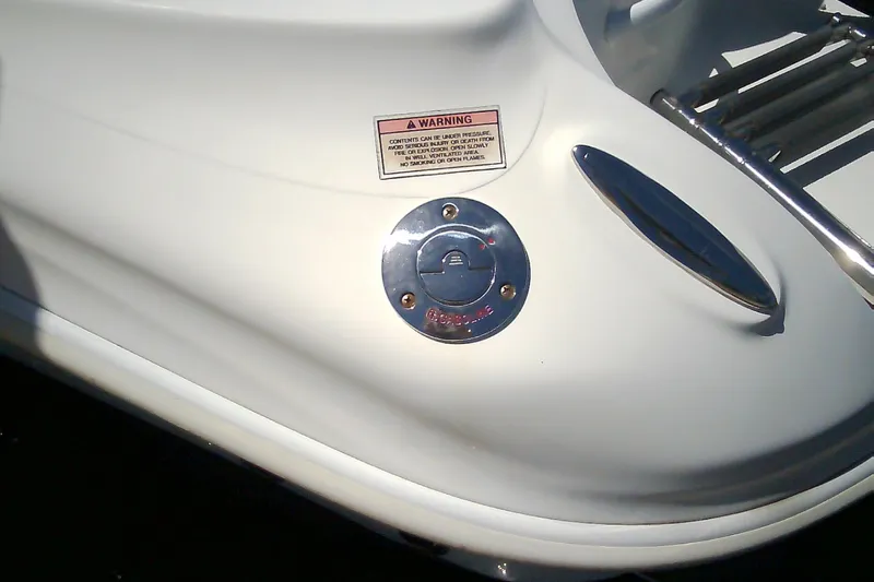 Slide: The Image of Fuel cap and warning label on 2021 Glasstream 240 CCX boat. - 55