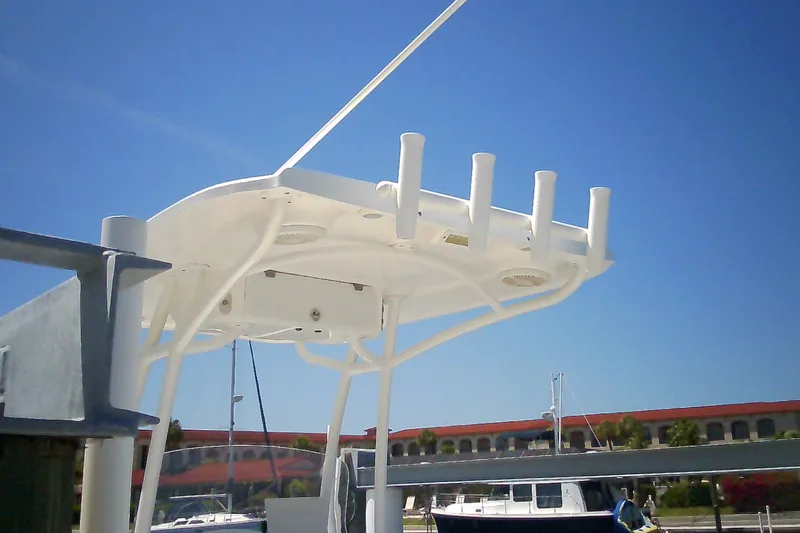 Slide: The Image of T-top of 2021 Glasstream 240 CCX boat with rod holders against clear blue sky. - 56