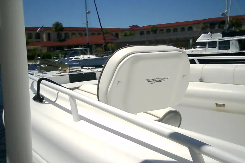 Slide: The Image of 2021 Glasstream 240 CCX boat interior with white seating at a marina. - 59