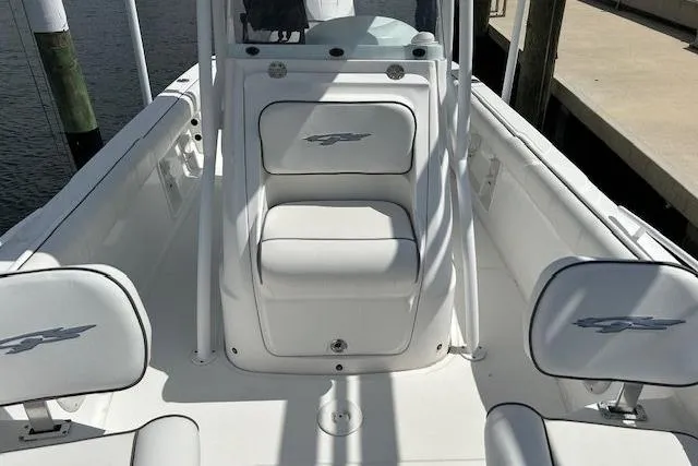 Slide: The Image of 2021 Glasstream 240 CCX boat interior with steering wheel, docked by the water. - 7