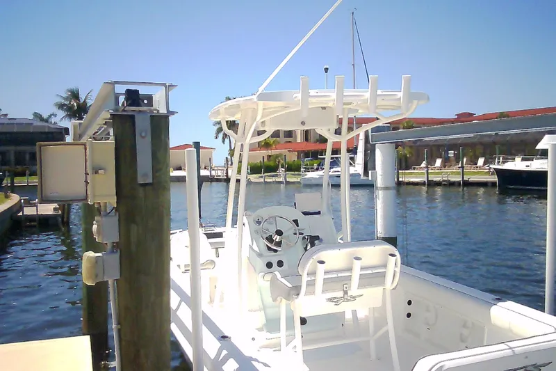 Slide: The Image of 2021 Glasstream 240 CCX boat docked at a marina under clear blue skies. - 8