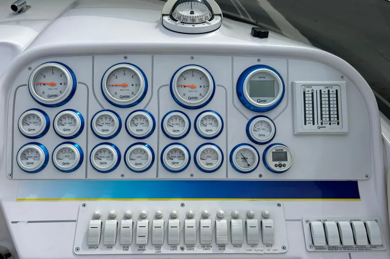 Slide: The Image of Dashboard of a 2001 Donzi boat with multiple gauges and controls. - 14