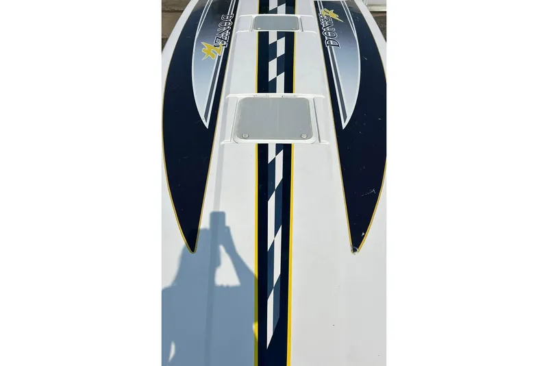 Slide: The Image of Top view of a 2001 Donzi boat with sleek blue and yellow design. - 16