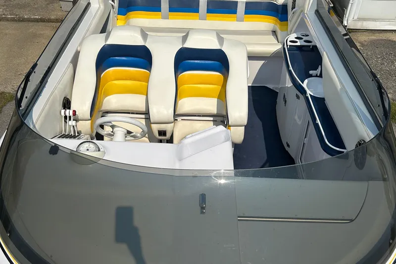 Slide: The Image of 2001 Donzi boat interior with colorful seating and steering wheel. - 17