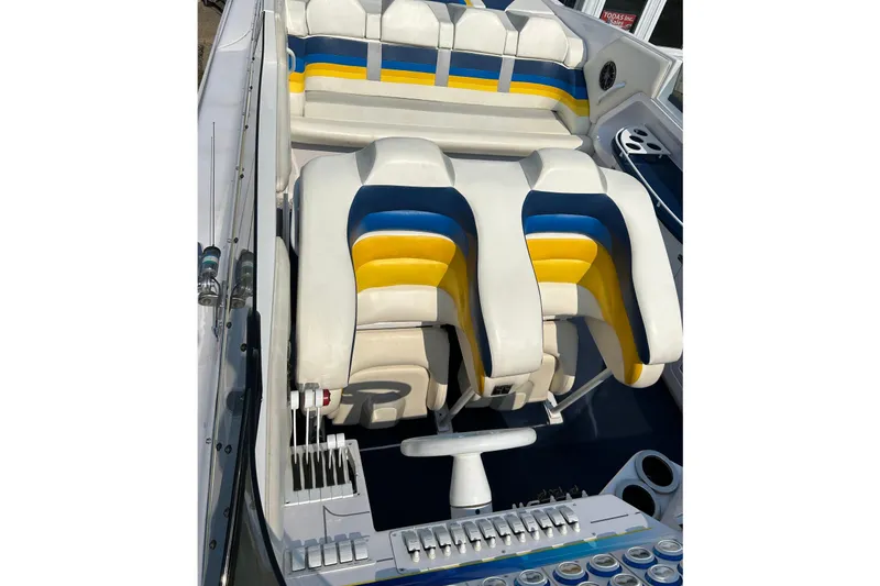 Slide: The Image of Interior of a 2001 Donzi boat featuring colorful seating and control panel. - 18