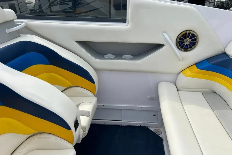 Slide: The Image of Interior of a 2001 Donzi boat with blue and yellow seating and speaker detail. - 19