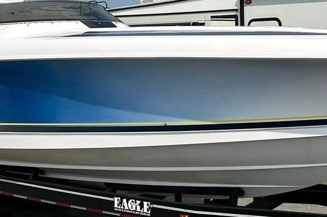 Slide: The Image of 2001 Donzi boat on trailer, featuring sleek blue and white design. - 2