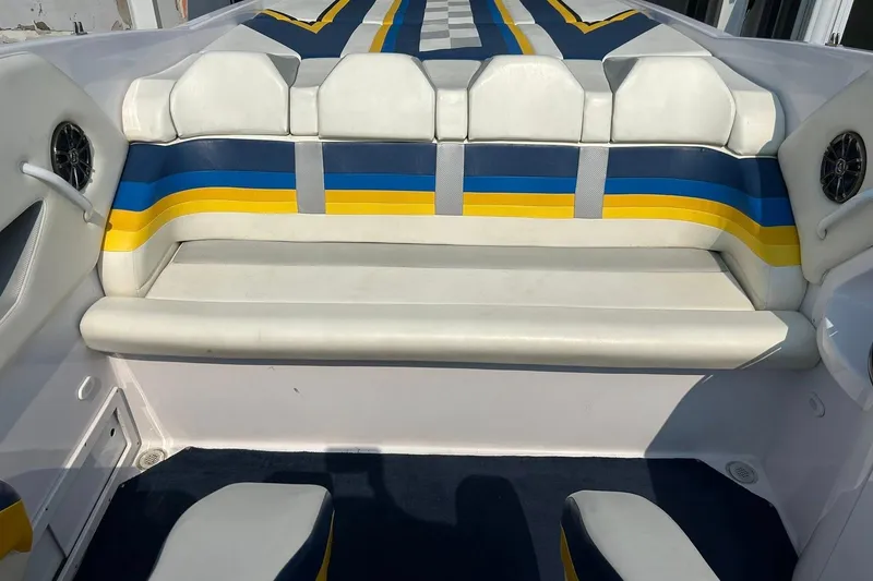 Slide: The Image of 2001 Donzi boat interior with white, blue, and yellow seating. - 20