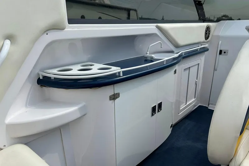 Slide: The Image of 2001 Donzi boat interior with sink, cup holders, and storage cabinets. - 21