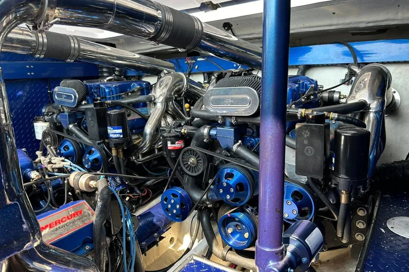 Slide: The Image of Engine compartment of a 2001 Donzi boat featuring dual Mercury engines and polished components. - 26
