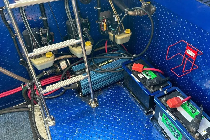 Slide: The Image of Engine compartment of a 2001 Donzi boat with batteries and wiring. - 27