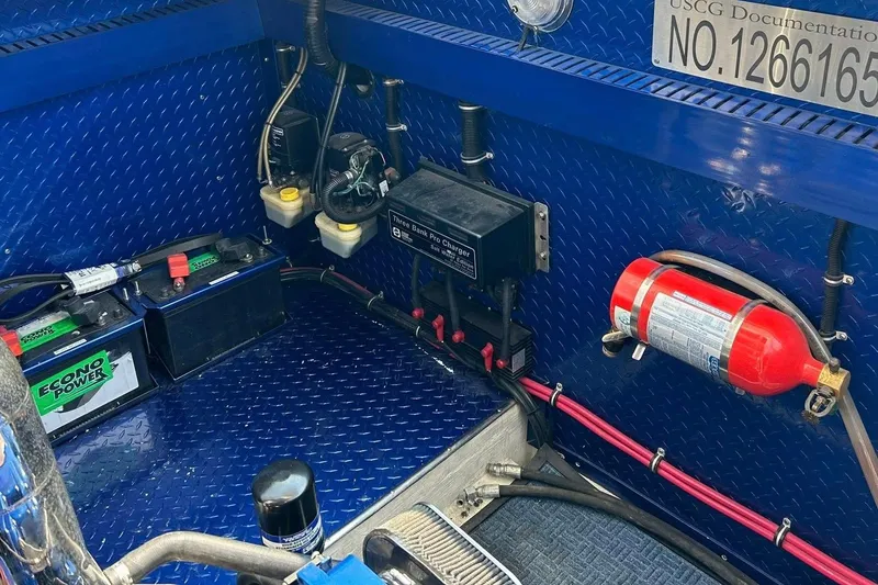 Slide: The Image of Engine compartment of a 2001 Donzi boat with batteries and fire extinguisher. - 28