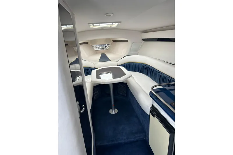 Slide: The Image of Interior of a 2001 Donzi boat featuring plush seating and a compact table. - 29
