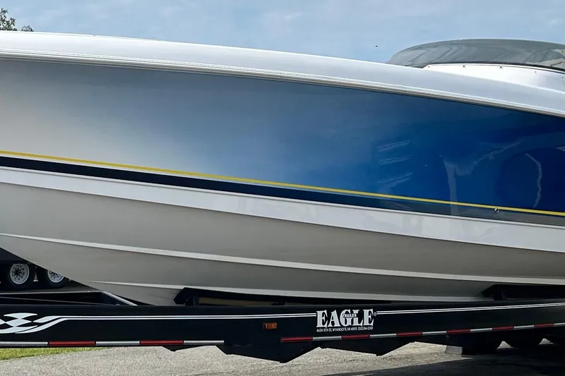 Slide: The Image of 2001 Donzi boat on trailer, featuring sleek blue and white design. - 3
