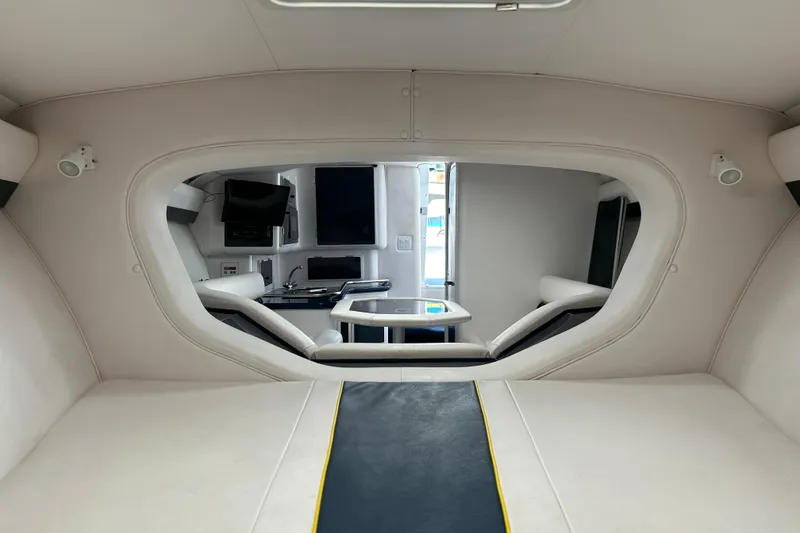 Slide: The Image of Interior of a 2001 Donzi boat featuring a modern cabin with seating and a table. - 31