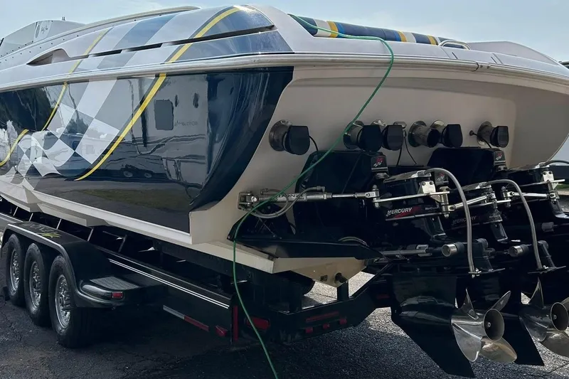 Slide: The Image of 2001 Donzi boat on trailer, featuring powerful Mercury engines and sleek design. - 6