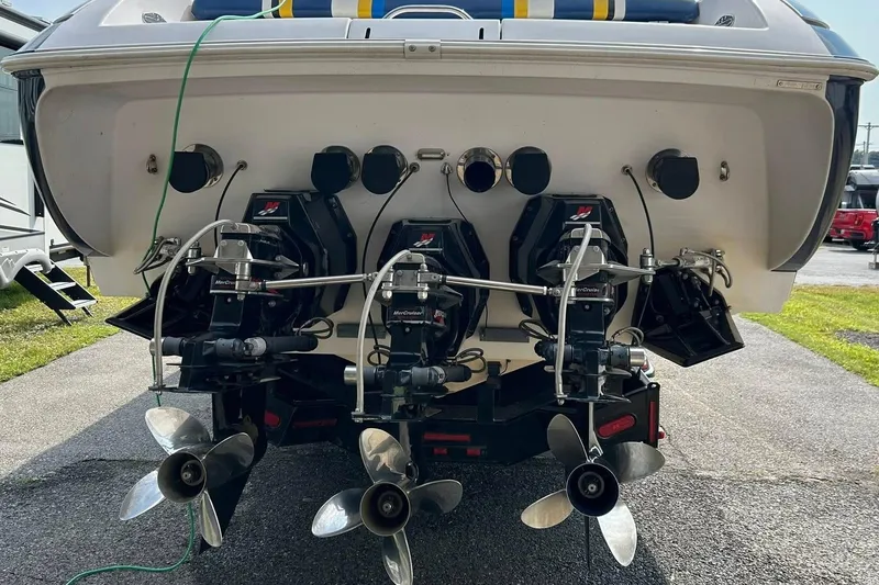 Slide: The Image of Rear view of a 2001 Donzi boat with triple MerCruiser outboard engines. - 8