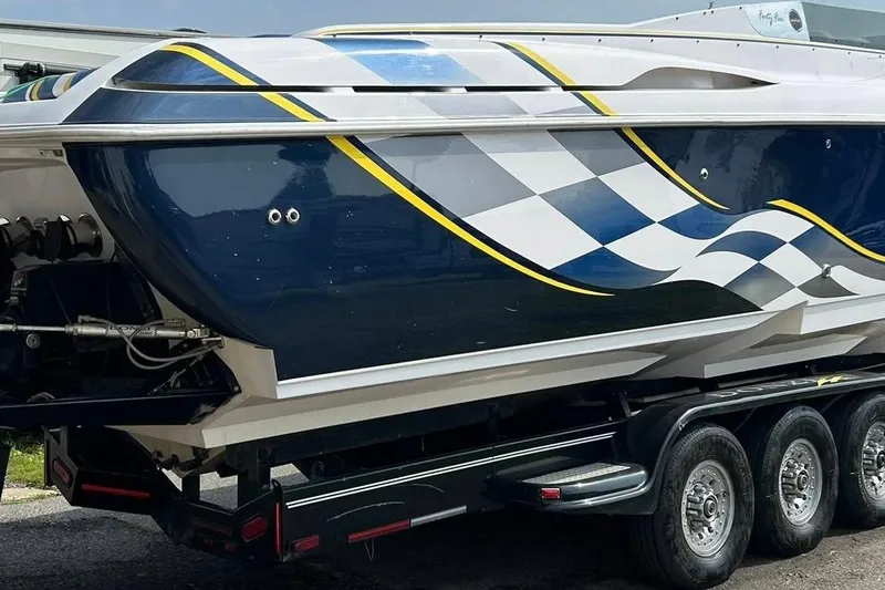 Slide: The Image of 2001 Donzi boat with checkered flag design on trailer. - 9