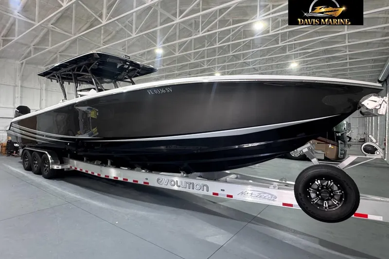 The Image of 2021 Nor-Tech 390 Sport Center Console boat on trailer in indoor storage facility. - 0
