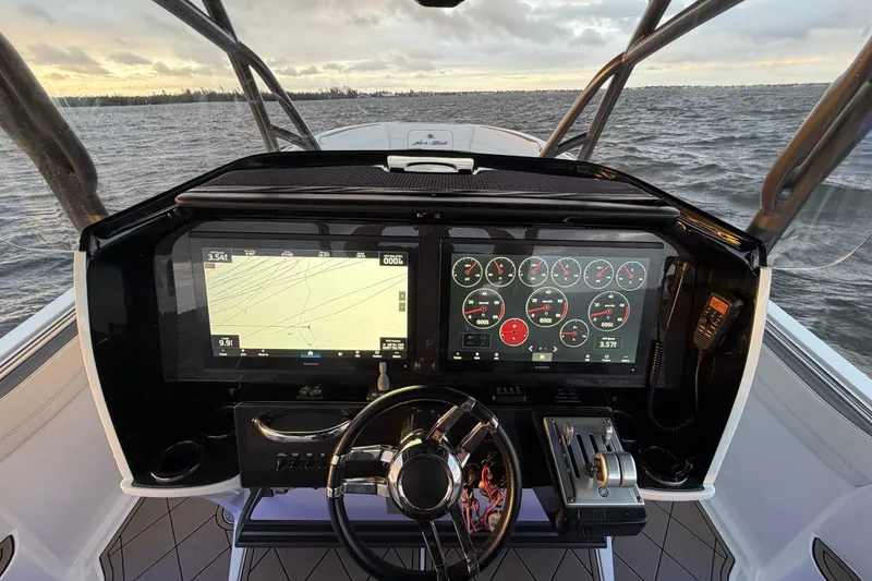 Slide: The Image of 2021 Nor-Tech 390 Sport Center Console helm with advanced navigation and control systems. - 10