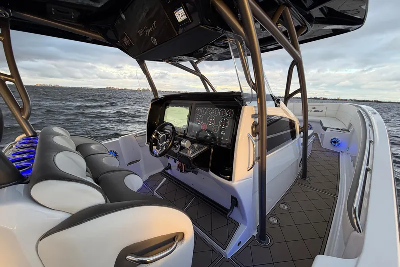 Slide: The Image of 2021 Nor-Tech 390 Sport Center Console boat interior with advanced dashboard on open water. - 12