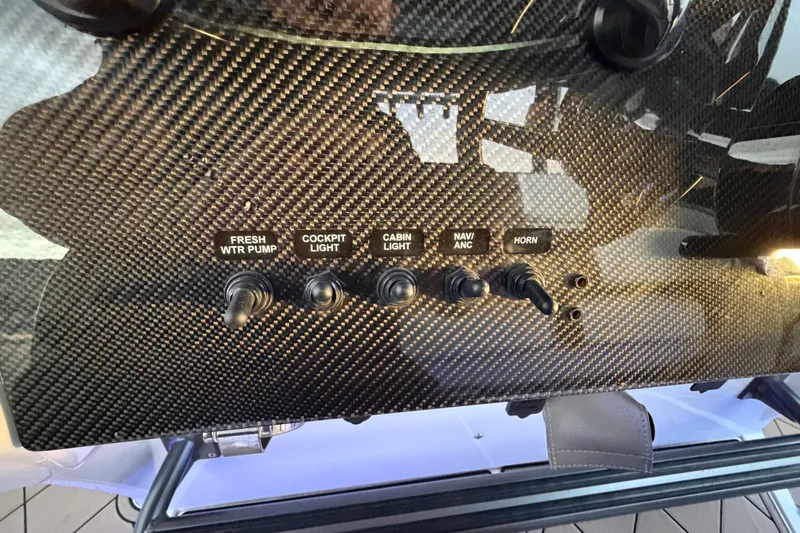 Slide: The Image of Carbon fiber control panel on 2021 Nor-Tech 390 Sport Center Console boat. - 15