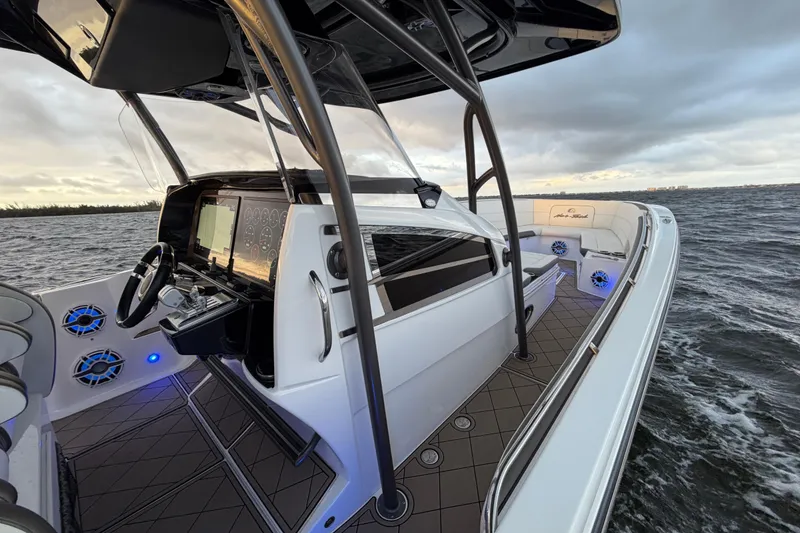 Slide: The Image of 2021 Nor-Tech 390 Sport Center Console on water, featuring sleek design and advanced controls. - 16