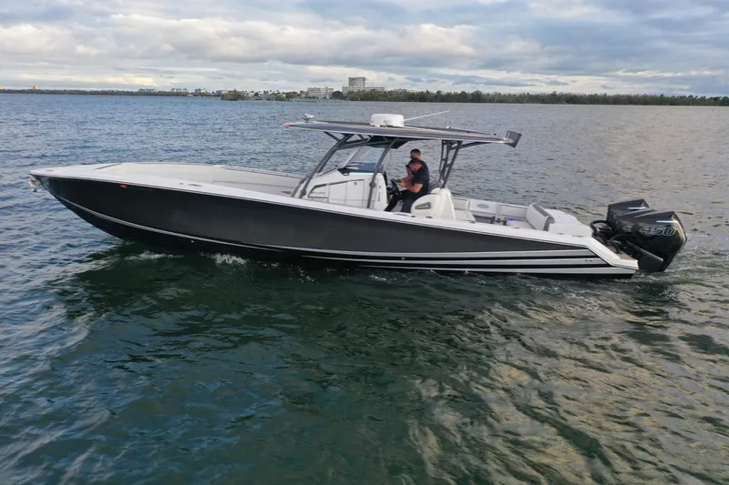 Slide: The Image of 2021 Nor-Tech 390 Sport Center Console boat cruising on open water. - 2