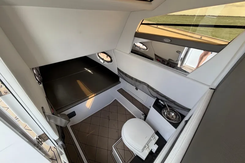 Slide: The Image of Interior of 2021 Nor-Tech 390 Sport Center Console with bed and compact bathroom. - 20