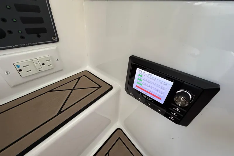 Slide: The Image of Control panel and audio system on 2021 Nor-Tech 390 Sport Center Console boat. - 22