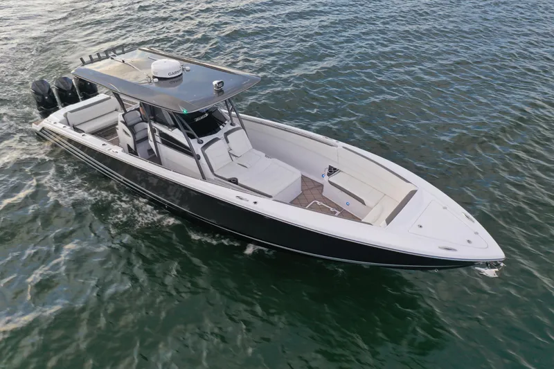 Slide: The Image of 2021 Nor-Tech 390 Sport Center Console boat cruising on open water. - 3